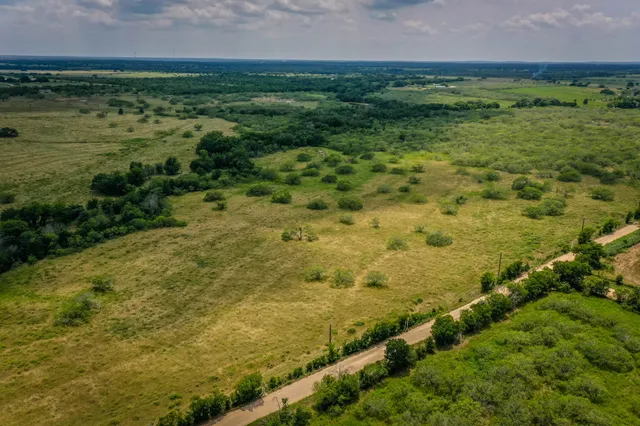 a view of a field with an ocean