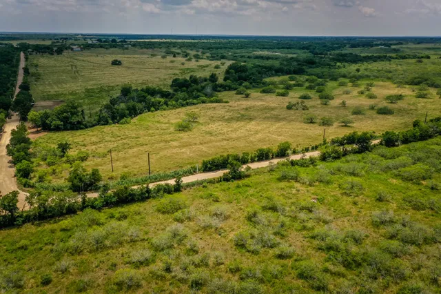 a view of a field with an ocean view