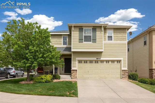 a view of a house with a yard and a fountain