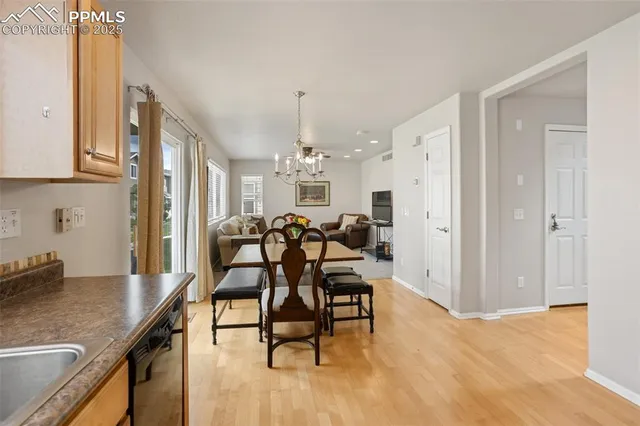 a view of a dining room with furniture and a chandelier