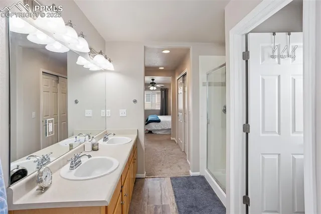 a en suite bathroom with a sink a mirror and a shower