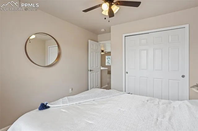 a bedroom with a large bed and a chandelier