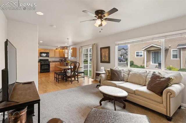 a living room with furniture and kitchen view