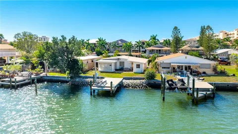a backyard of a house with yard table and chairs