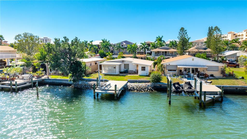 a backyard of a house with yard table and chairs