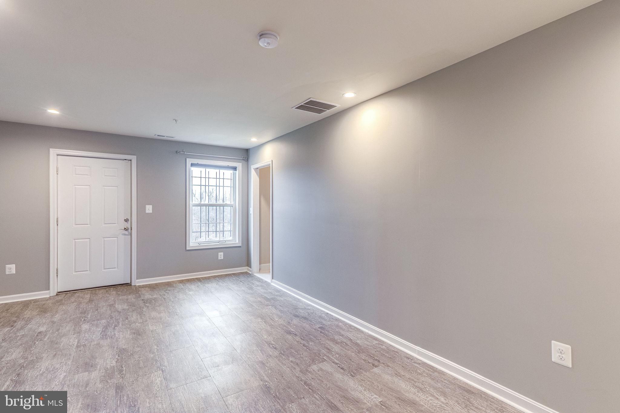 2508 Elvans Road Southeast Washington, DC 20020 - Photo 11 of 45 Family room has laminate wood.