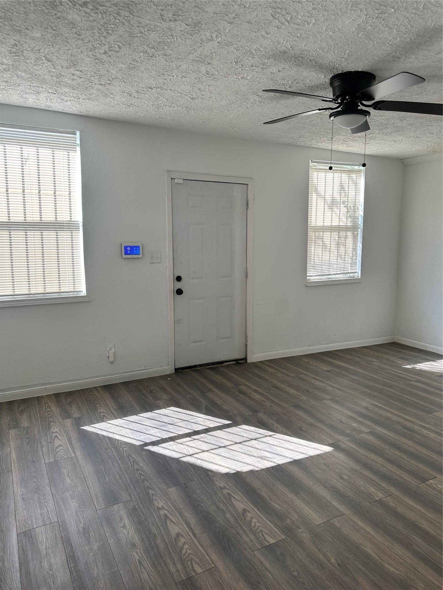 978 Ringold Street, Unit B Houston, TX 77088 - Photo 2 of 12 an empty room with wooden floor cabinet and windows