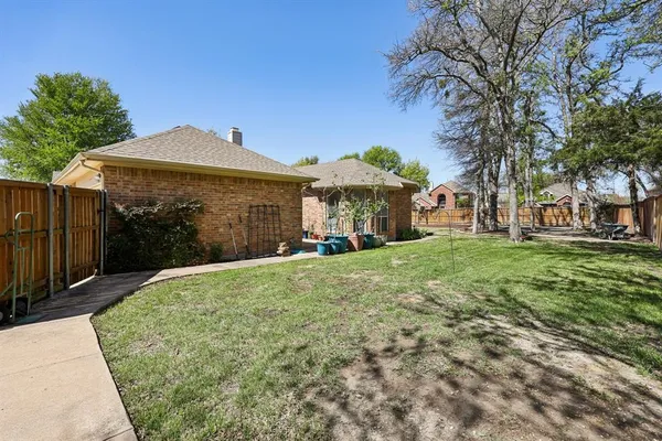 a view of a backyard with large trees