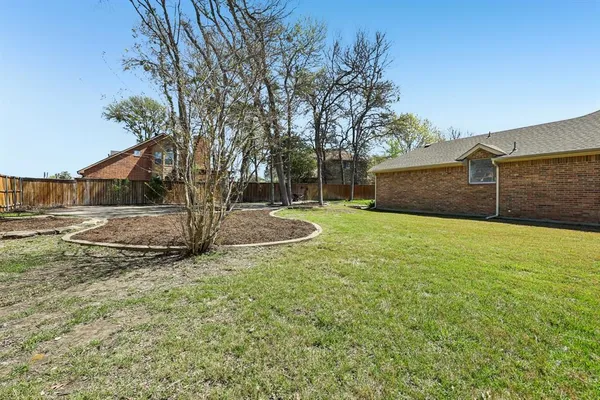 an aerial view of a house with a garden and swimming pool