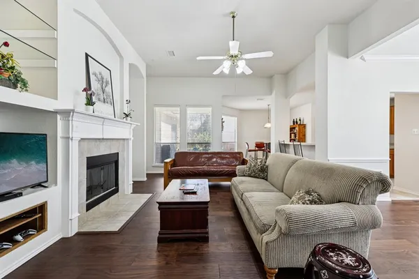 a living room with furniture and a chandelier