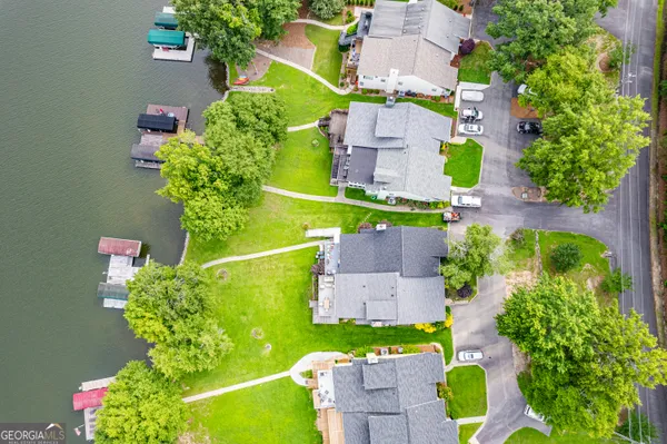 an aerial view of a houses with a lake view