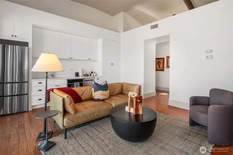 a living room with furniture and a lamp