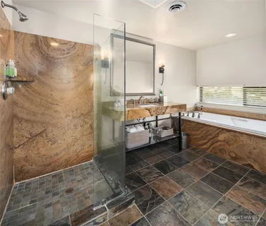 a bathroom with a sink mirror toilet and bathtub