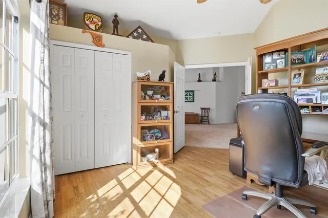 a view of a workspace with furniture and a window