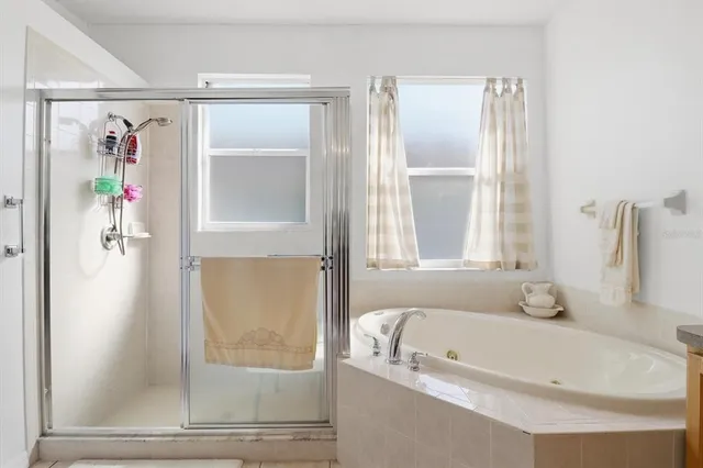 a white bath tub sitting next to a window
