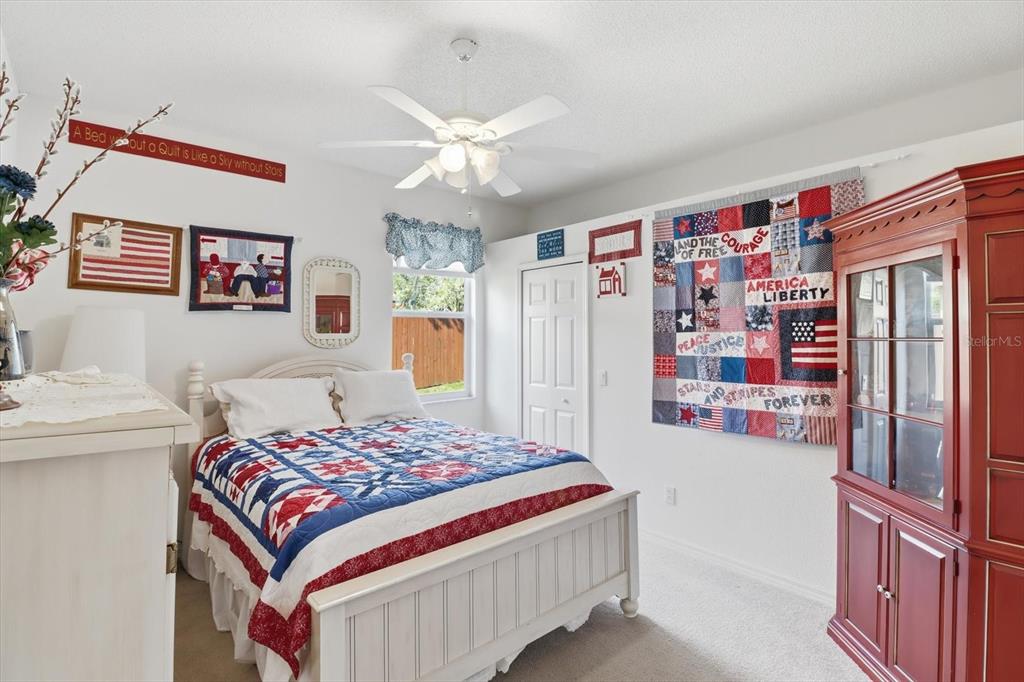 63 North Youngtree Point Lecanto, FL 34461 - Photo 24 of 48 a bedroom with a bed and a chandelier