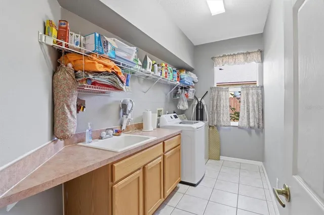 a utility room with cabinets a washer and dryer