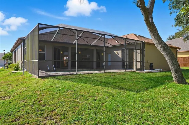 a backyard of a house with table and chairs