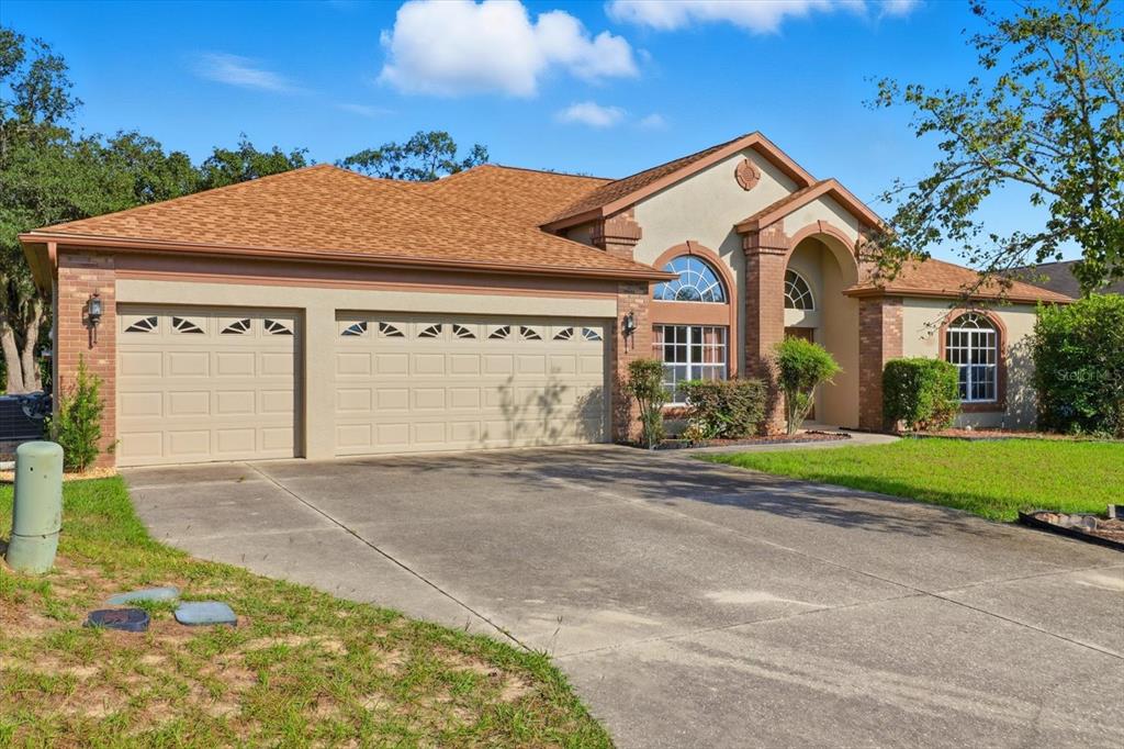 63 North Youngtree Point Lecanto, FL 34461 - Photo 45 of 48 a front view of a house with a yard and garage