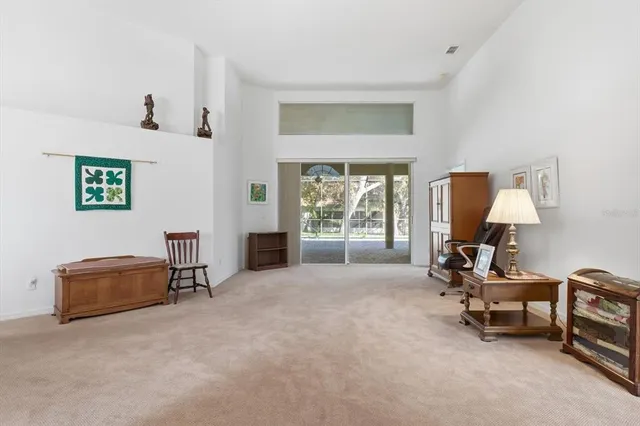 a view of a livingroom with workspace and a window