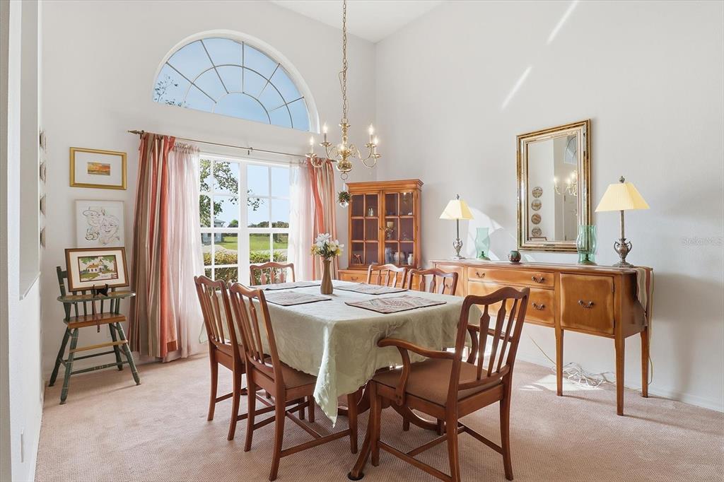 63 North Youngtree Point Lecanto, FL 34461 - Photo 9 of 48 a dining room with wooden floor a chandelier a wooden table and chairs