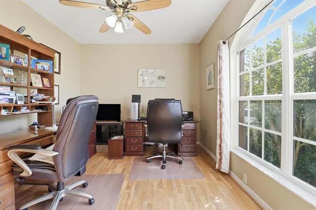 a view of workspace with wooden floor windows