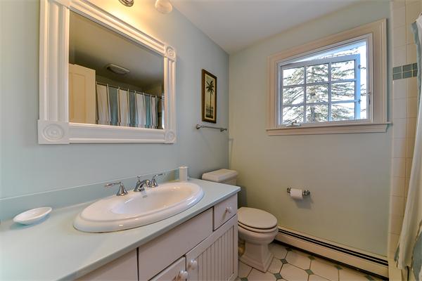 24 Hillside Road Wellesley, MA 02481 - Photo 14 of 17 a bathroom with a toilet sink and mirror