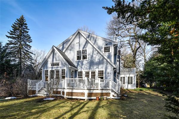 24 Hillside Road Wellesley, MA 02481 - Photo 17 of 17 a view of a white house next to a yard with large trees