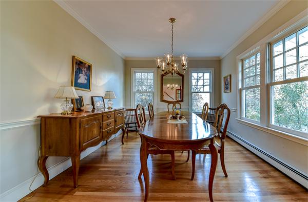 24 Hillside Road Wellesley, MA 02481 - Photo 6 of 17 a dining room with wooden floor a chandelier a wooden table and chairs
