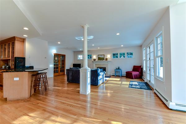 24 Hillside Road Wellesley, MA 02481 - Photo 9 of 17 a living room with furniture a wooden floor and kitchen view