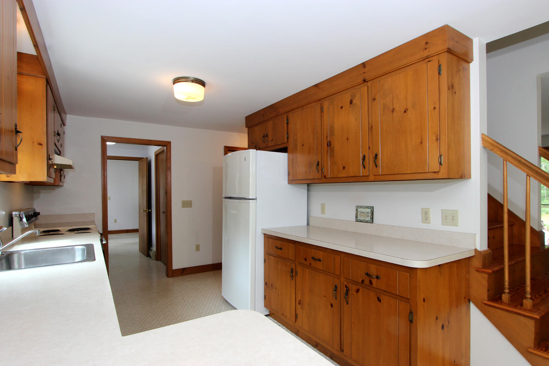 216 Cathedral Road Brewster, MA 02631 - Photo 12 of 56 a kitchen with stainless steel appliances granite countertop a sink stove and refrigerator