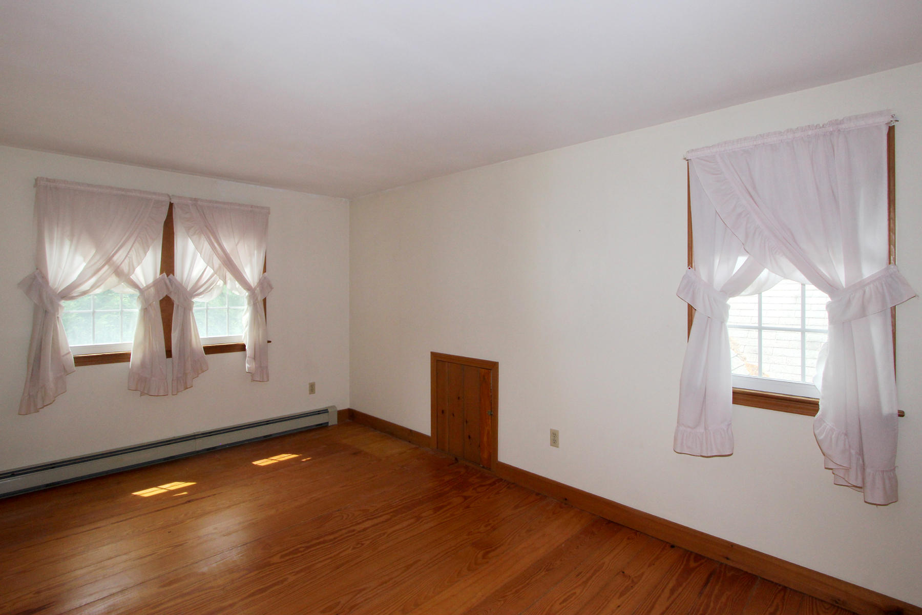 216 Cathedral Road Brewster, MA 02631 - Photo 24 of 56 an empty room with wooden floor and windows