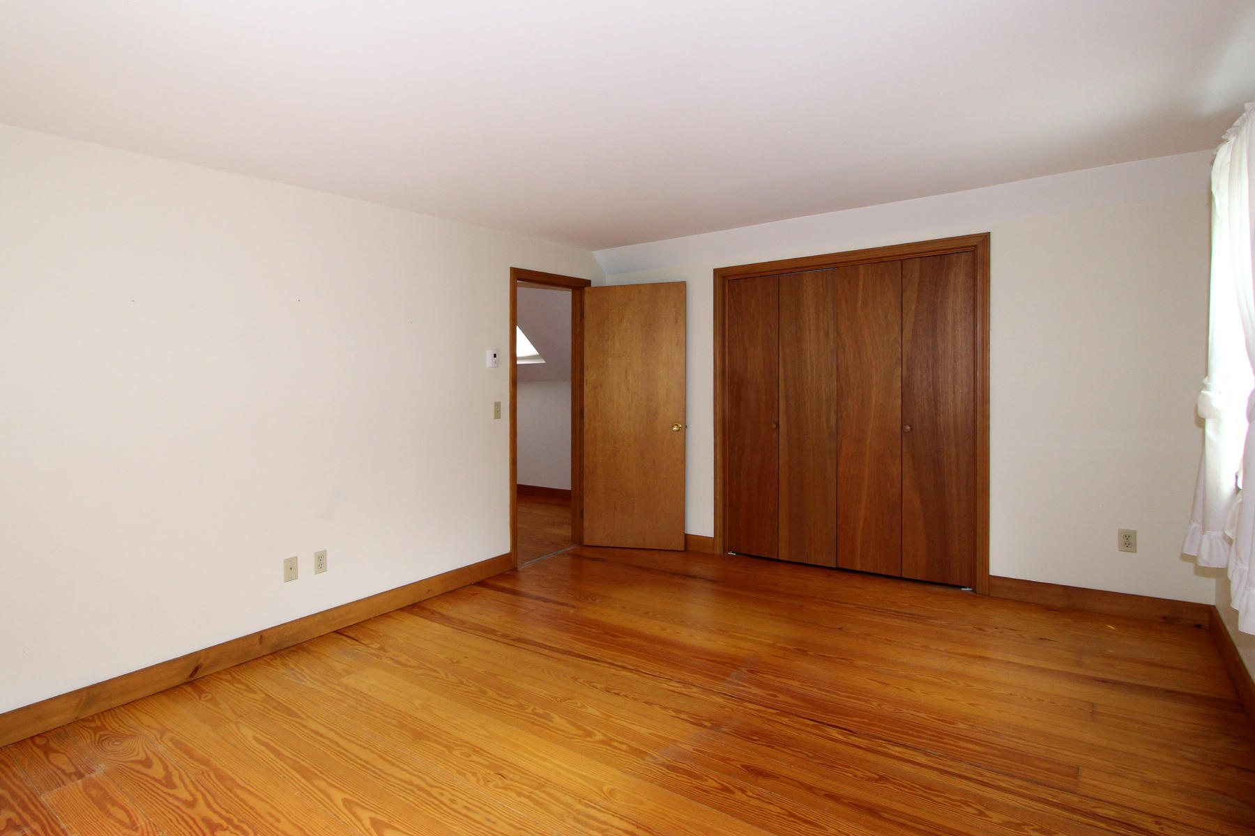 216 Cathedral Road Brewster, MA 02631 - Photo 28 of 56 a view of an empty room with wooden floor