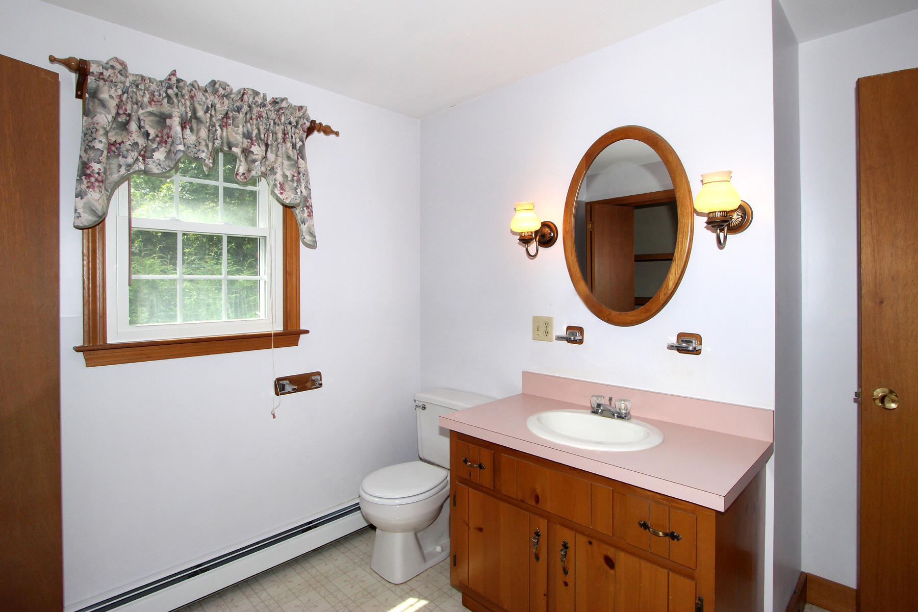 216 Cathedral Road Brewster, MA 02631 - Photo 30 of 56 a bathroom with a sink a mirror a toilet and a window