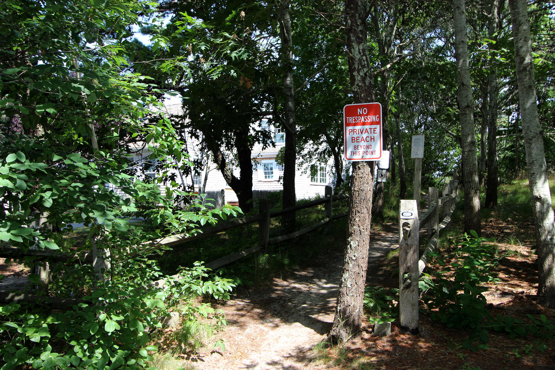 216 Cathedral Road Brewster, MA 02631 - Photo 50 of 56 a sign that is sitting in a forest