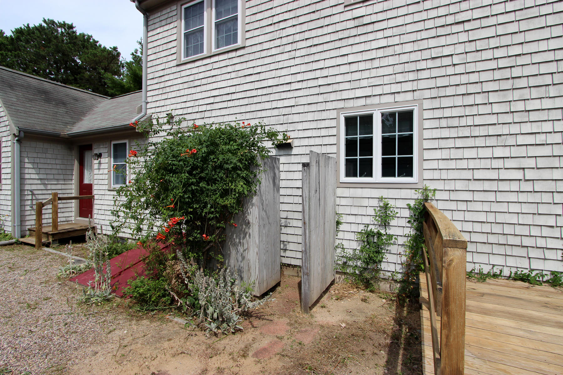 216 Cathedral Road Brewster, MA 02631 - Photo 5 of 56 a view of a house with a yard and potted plants