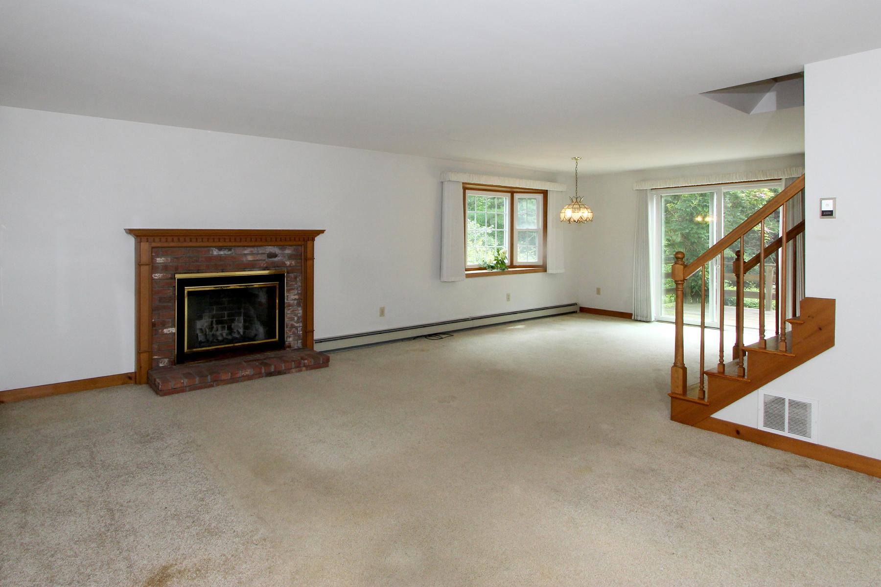 216 Cathedral Road Brewster, MA 02631 - Photo 8 of 56 a view of empty room with fireplace and windows