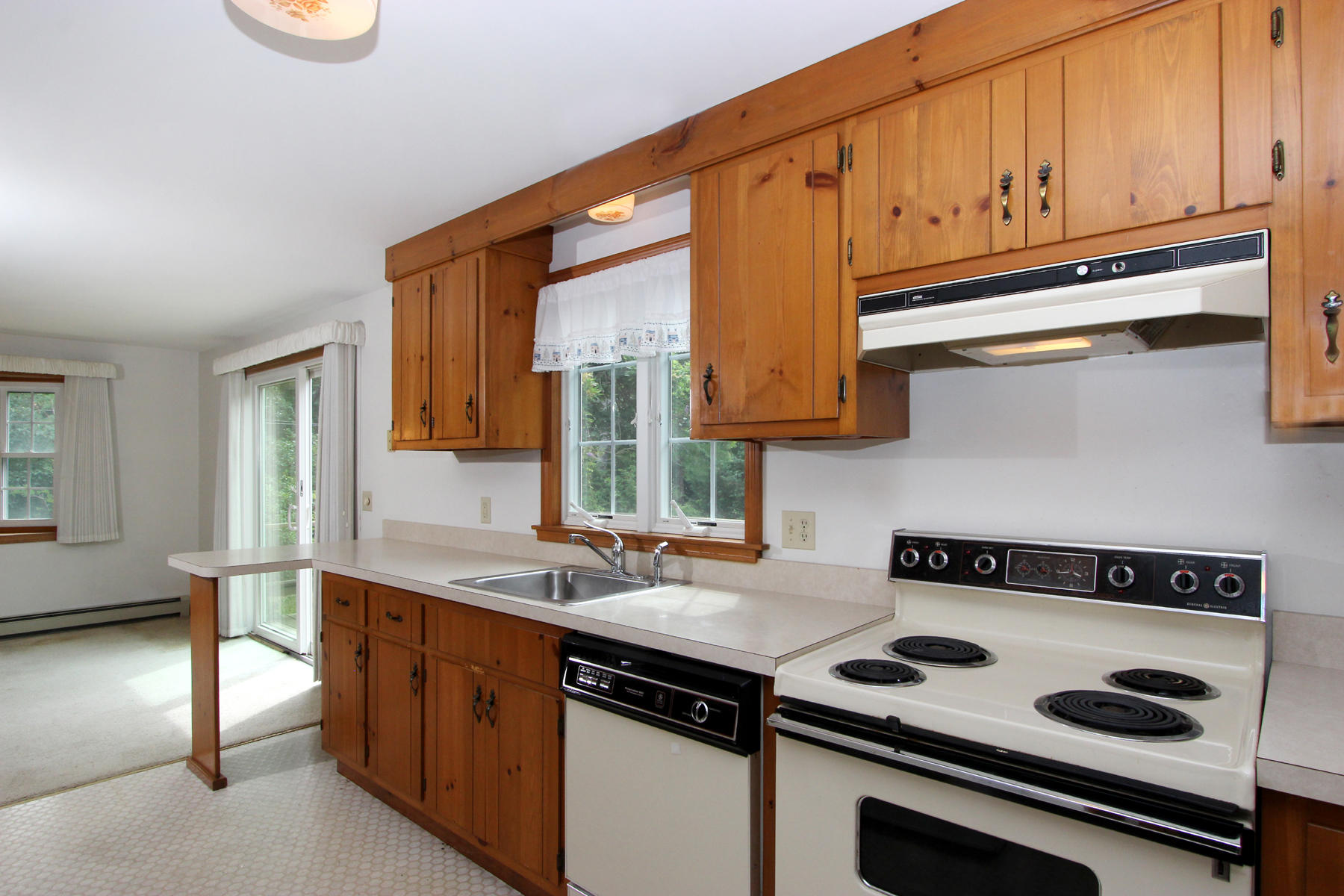 216 Cathedral Road Brewster, MA 02631 - Photo 10 of 56 a kitchen with granite countertop a stove and a sink