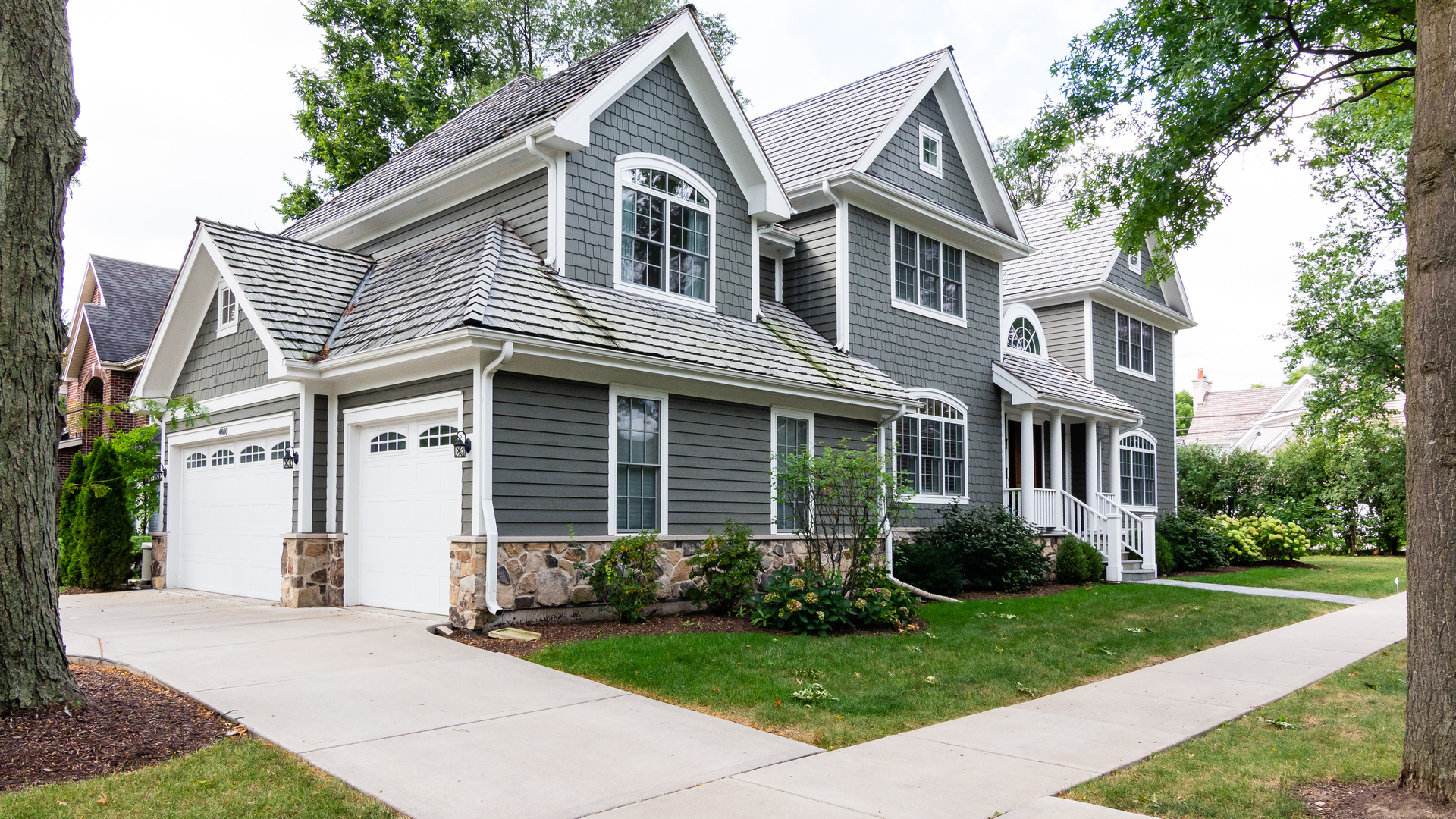 4800 Wolf Road Western Springs, IL 60558 - Photo 1 of 47 a front view of a house with a garden