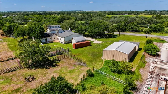 an aerial view of residential house with outdoor space and swimming pool