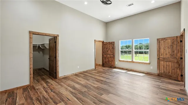 a bathroom with a toilet a sink a mirror and a shower