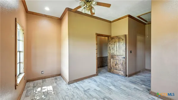 a bathroom with a granite countertop sink and a window