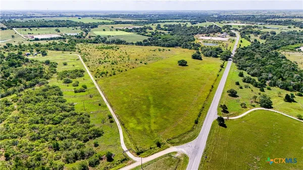 an aerial view of a house with a yard basket ball court and outdoor seating