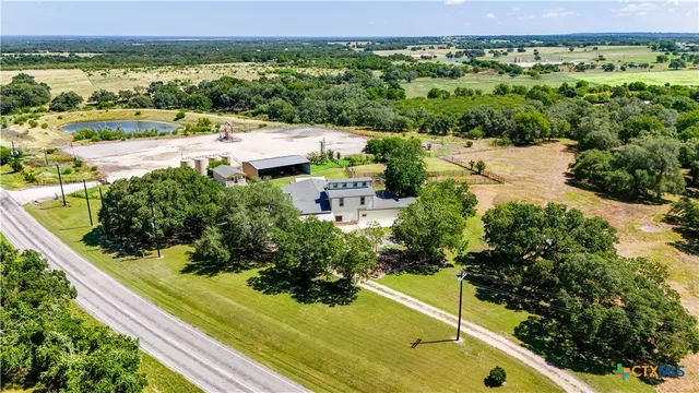 an aerial view of a house with garden space and street view