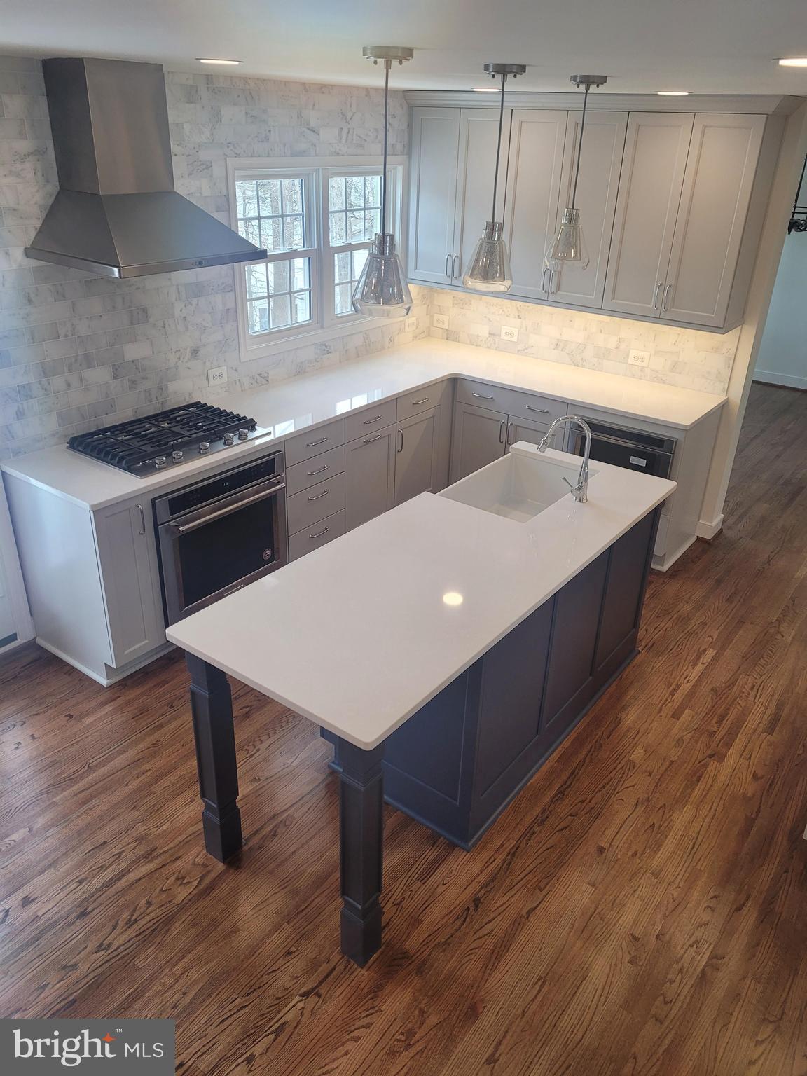 6600 Kensal Court Springfield, VA 22152 - Photo 12 of 43 a kitchen with a wooden floor and a stove top oven