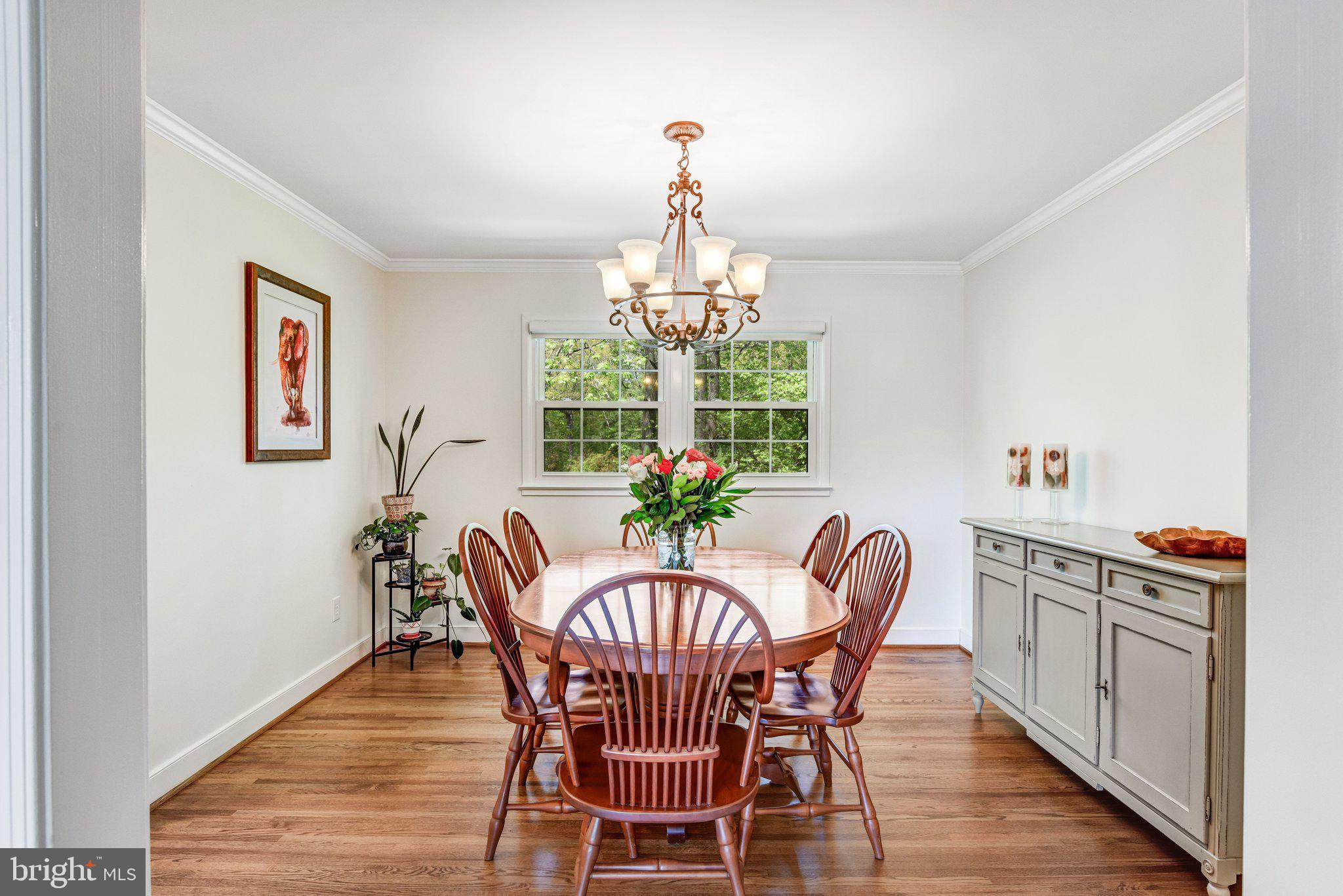 6600 Kensal Court Springfield, VA 22152 - Photo 16 of 43 a dining room with furniture a chandelier and wooden floor