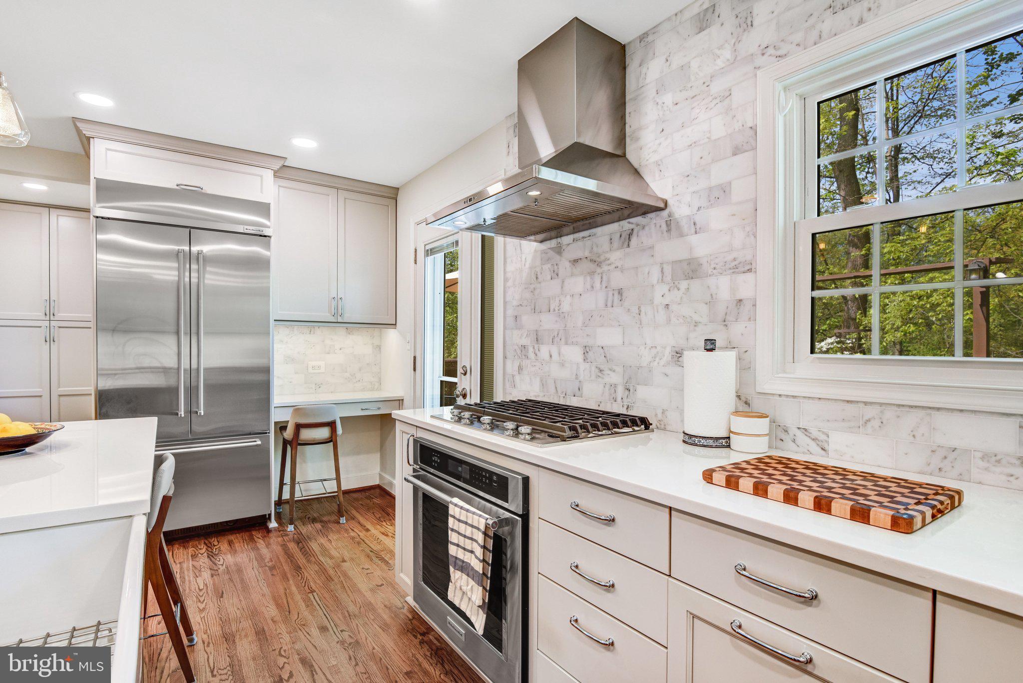 6600 Kensal Court Springfield, VA 22152 - Photo 23 of 43 a kitchen with stainless steel appliances granite countertop a stove a sink and a refrigerator