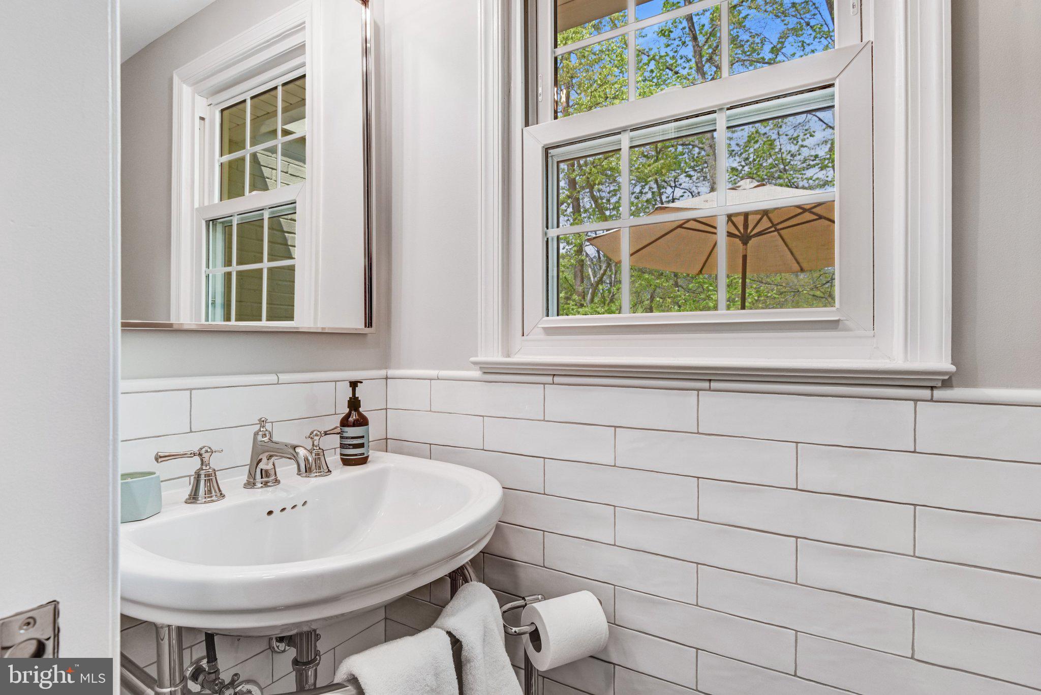 6600 Kensal Court Springfield, VA 22152 - Photo 24 of 43 a bathroom with a sink a toilet and a window