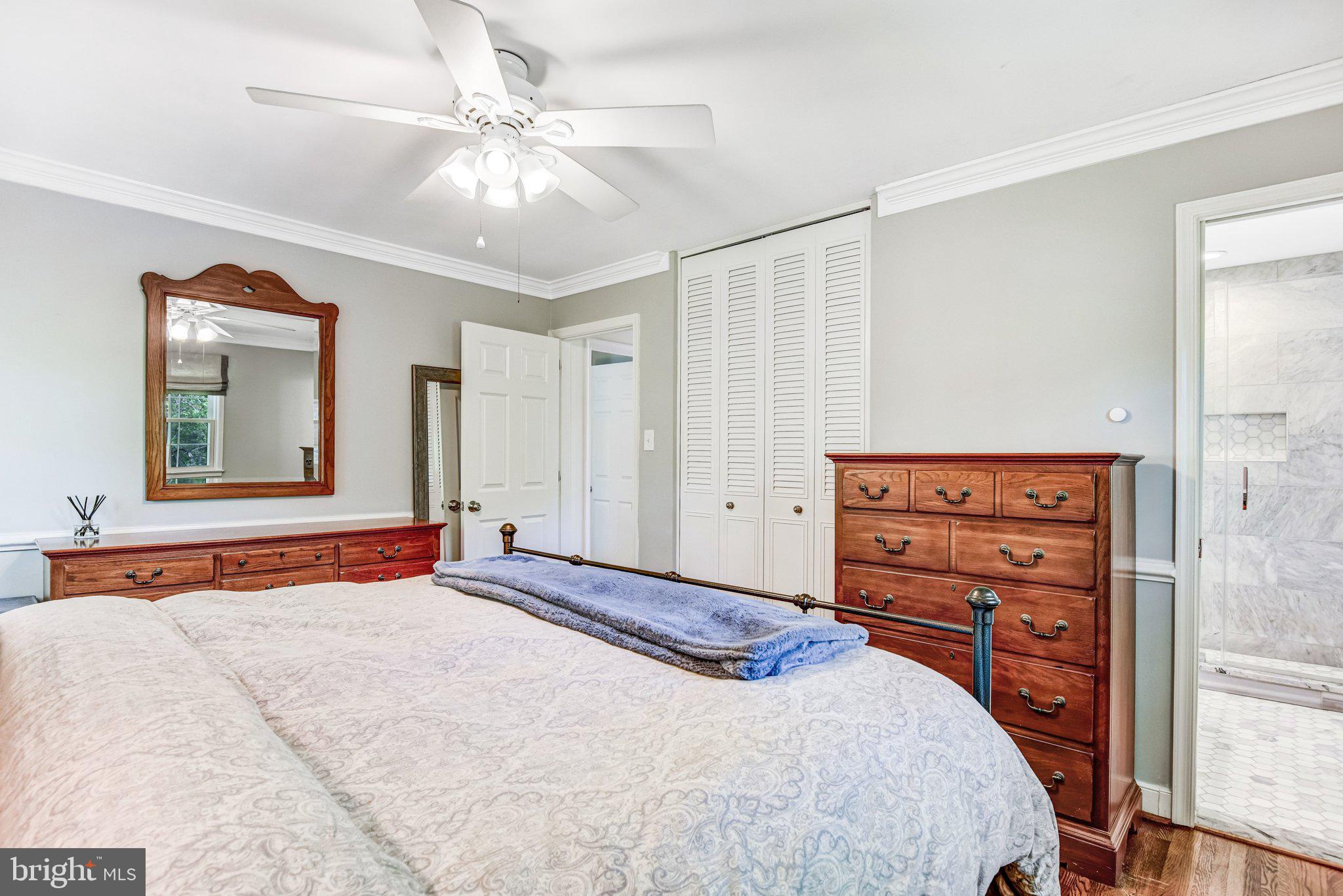 6600 Kensal Court Springfield, VA 22152 - Photo 26 of 43 a bedroom with a large bed and a chandelier