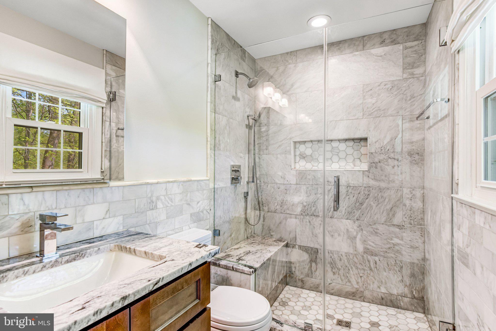 6600 Kensal Court Springfield, VA 22152 - Photo 27 of 43 a bathroom with a granite countertop sink toilet and shower